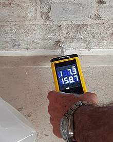 Edmonton Home Inspector Using Moisture Meter Checking For Water Damage at A Home Inspection in Edmonton, Home inspection services for real estate, property inspection near me metro edmonton